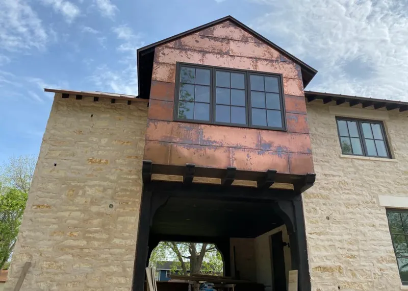 Copper metal panel facade on a stone building for Roof Repair in Fort Campbell North
